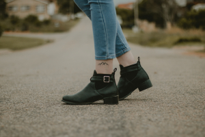 Cute, chunky, black ankle boots worn with blue denim jeans, above ankle length